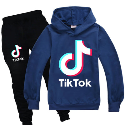 TikTok fashion sweater + black and gray trousers