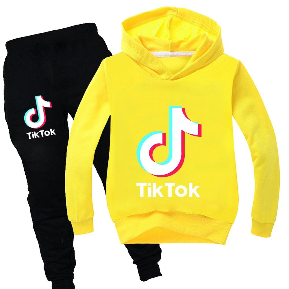 TikTok fashion sweater + black and gray trousers
